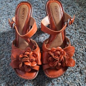 Born two strap sandals.  Orange leather with flower and heel.